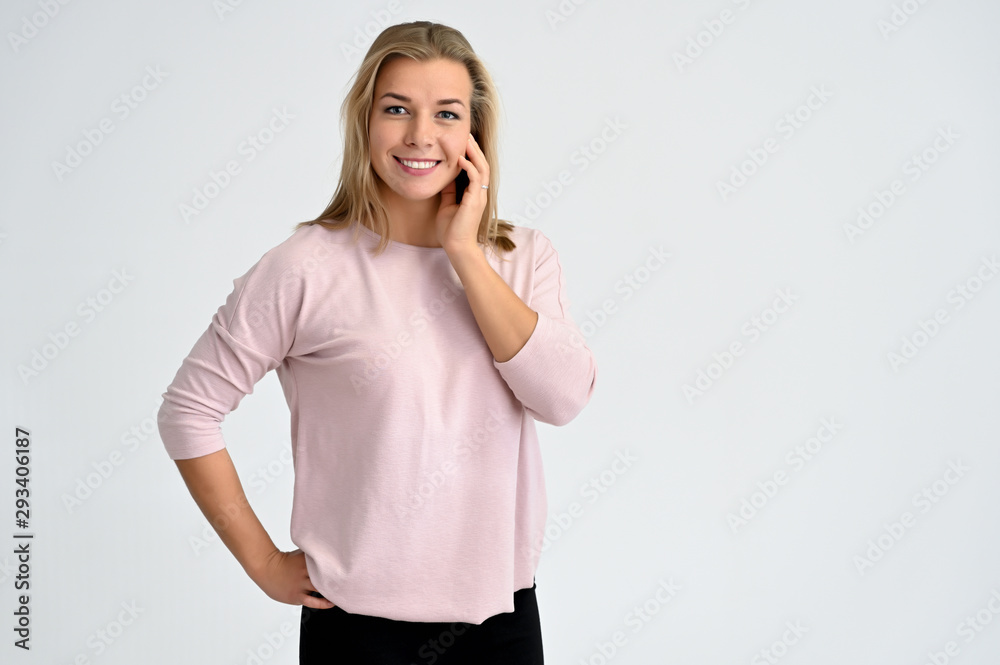Close-up portrait of a cute caucasian blonde female student girl in pink blouse on a white background. Wide smile, happiness. It is in different poses. Close-up portrait of a cute caucasian blonde female student girl in pink blouse on a white background. Wide smile, happiness. It is in different poses.
