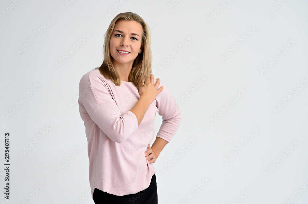 Close-up portrait of a cute caucasian blonde female student girl in pink blouse on a white background. Wide smile, happiness. It is in different poses. Close-up portrait of a cute caucasian blonde female student girl in pink blouse on a white background. Wide smile, happiness. It is in different poses.