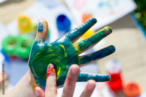 Summer. Open space.  Hands painted with colored paint. Body paint.