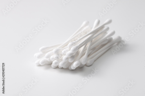 A pile of cotton swabs on a gray background. Space for text