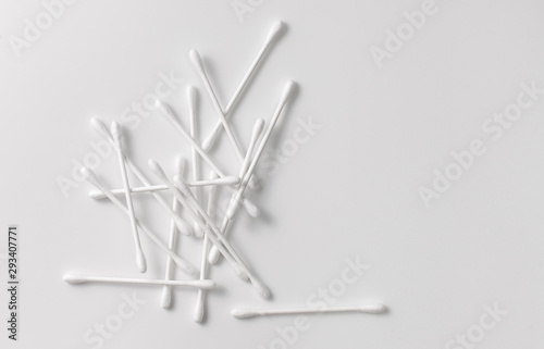 A pile of cotton swabs on a gray background. Space for text
