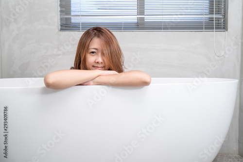 Portrait of young attractive asian girl takes a bath with candles relax in the bathroom. Beauty woman in spa treatments. Healthy perfect glow skin care concept