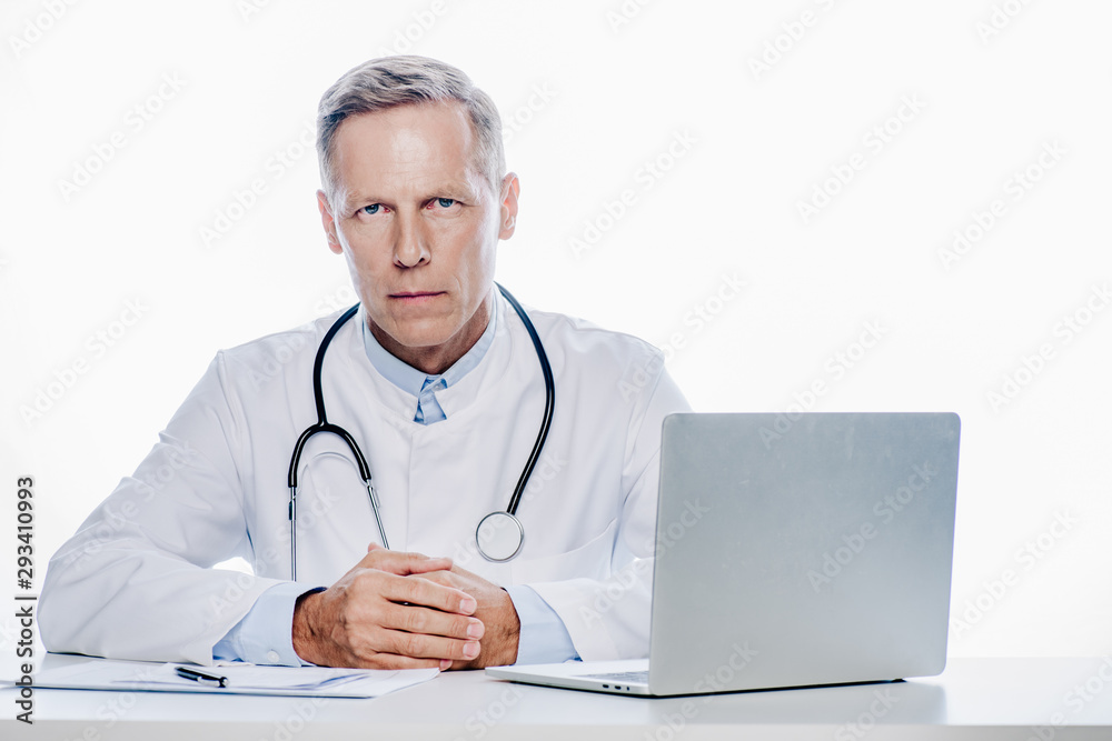 handsome doctor in white coat looking at camera isolated on white handsome doctor in white coat looking at camera isolated on white