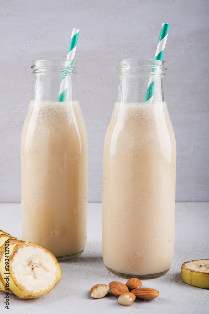 Fresh And Healthy Banana Smoothie In A Bottle With Almond And Sliced Banana Fresh And Healthy Banana Smoothie In A Bottle With Almond And Sliced Banana