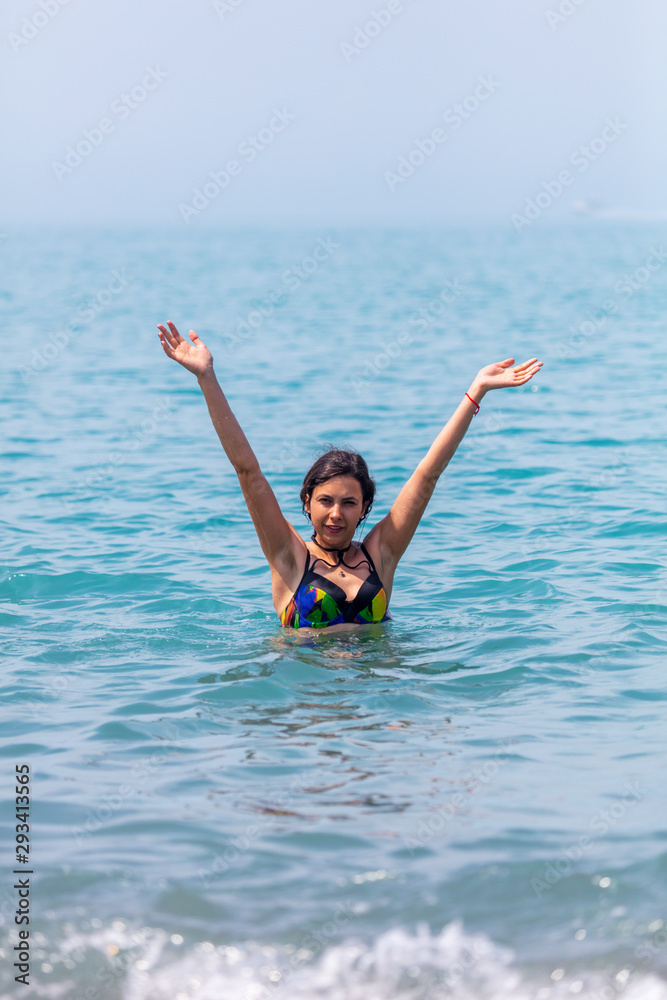 The girl bathes on the seashore