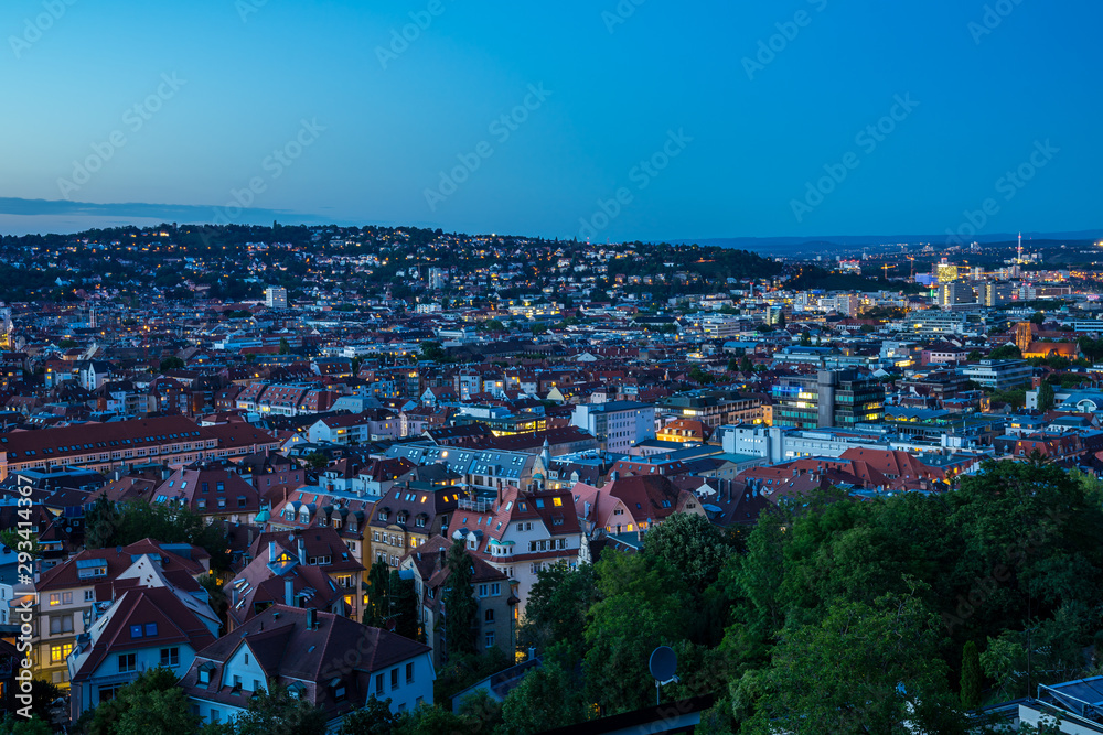 Germany, Aerial view over cityscape and skyline of big city stuttgart houses in basin after sunset, view from above