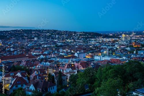 Germany, Aerial view over cityscape and skyline of big city stuttgart houses in basin after sunset, view from above © Simon
