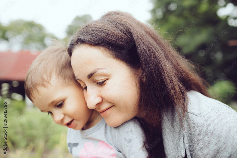Affectionate mother with toddler in garden Affectionate mother with toddler in garden