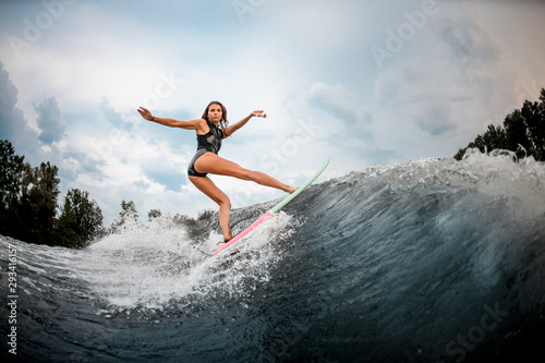 Girl wakesurfer performing stunts on a board