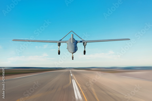 Unmanned military drone landing on runway military base.