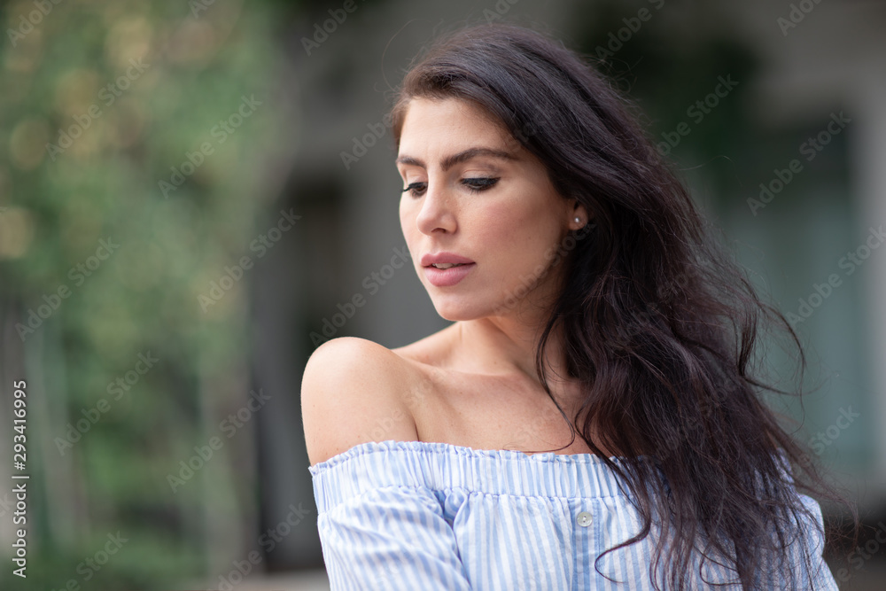 A portrait of a lovely romantic young woman outdoors, inspiringly looking forward A portrait of a lovely romantic young woman outdoors, inspiringly looking forward