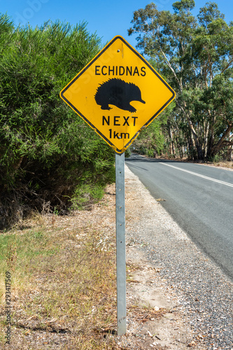 Fototapeta Naklejka Na Ścianę i Meble -  ‘Echidnas Crossing. Next 1km’ road sign in Australia.