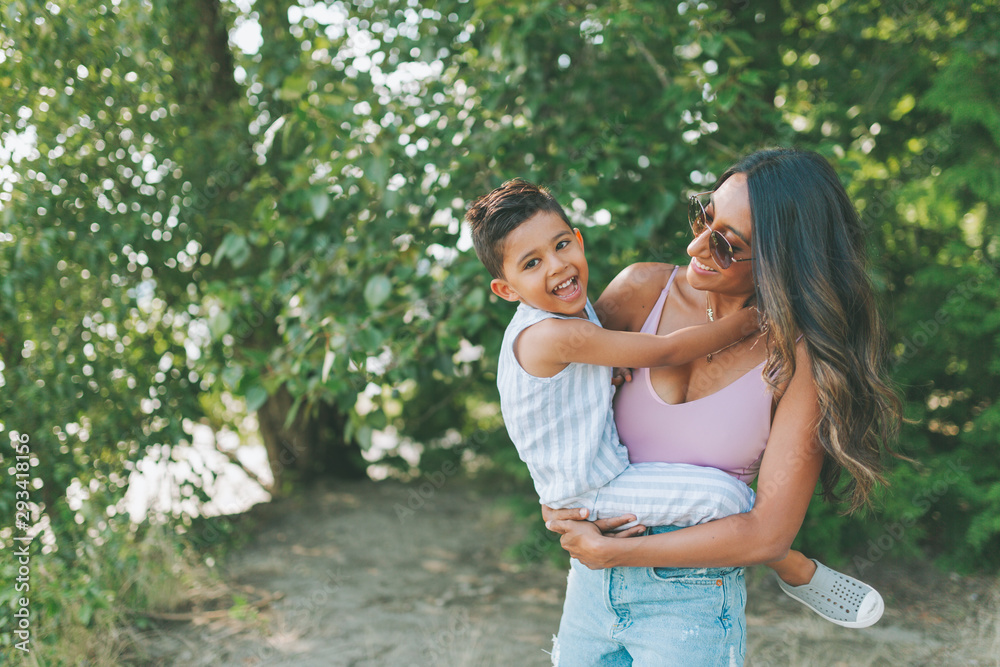 A happy mother and son playing together outside in the summer. A happy mother and son playing together outside in the summer.