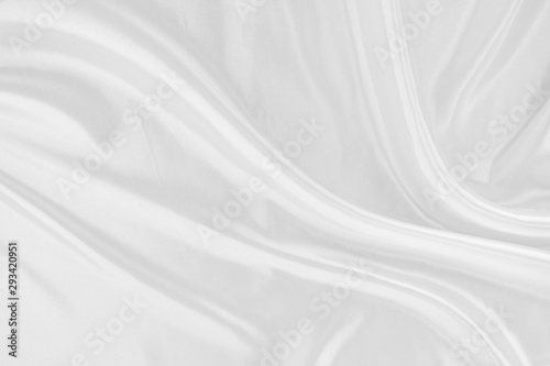 White fabric texture that is white silk background with beautiful soft blur pattern.