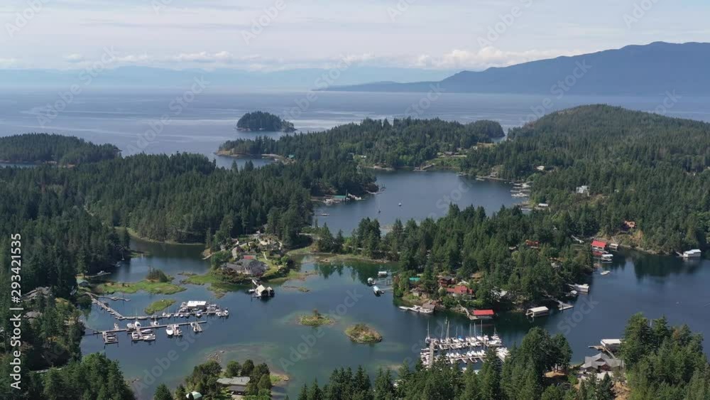 Aerial view over inlet, ocean and island with boat and mountains in beautiful British Columbia. Canada. 4K. Aerial view over inlet, ocean and island with boat and mountains in beautiful British Columbia. Canada. 4K.