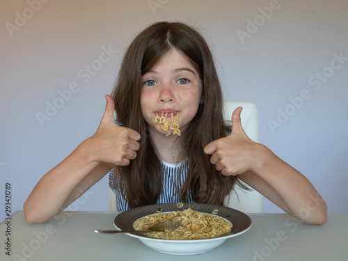 little girl eating chinese instant noodles  unhealthy eating concept  food addiction
