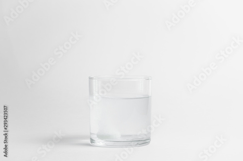 The effervescent tablet dissolves in a glass of water. Liquid medicine isolated on white background. Treatment of viral diseases. Help with depression and insomnia. Drink liquid multivitamins