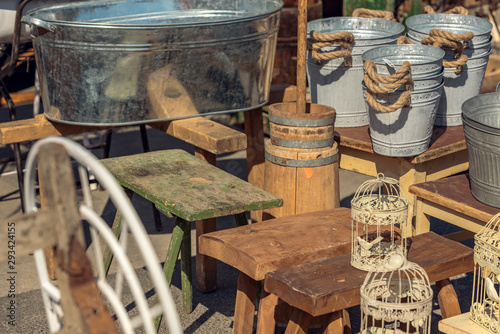 Market stall with objects and old things at the weekend flea market in the city center. Concept. Old objects for sale