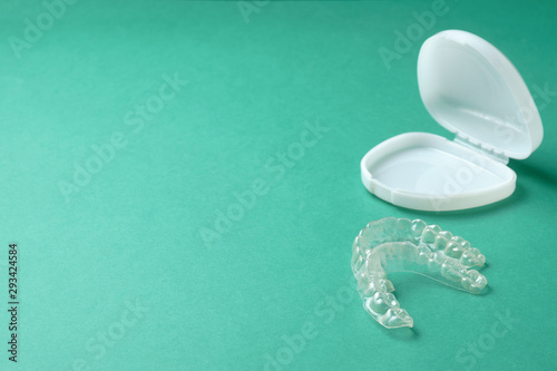 Plastic mouthguard for teeth whitening on a green background