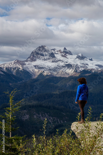 Adventurous Girl near a cliff enjoying the Beautiful Canadian Nature during a colorful and vibrant evening in Fall. Taken on a trail to Watersprite Lake near Squamish, North of Vancouver, BC, Canada.