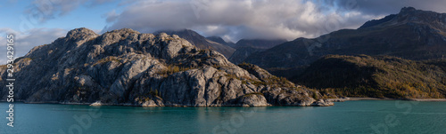 Beautiful Panoramic View of American Mountain Landscape on the Ocean Coast during a cloudy and colorful morning in fall season. Taken in Glacier Bay National Park and Preserve, Alaska, USA.