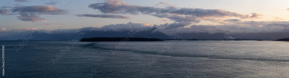 Beautiful Panoramic View of American Mountain Landscape on the Ocean Coast during a cloudy and colorful sunrise in fall season. Taken in Glacier Bay National Park and Preserve, Alaska, USA.