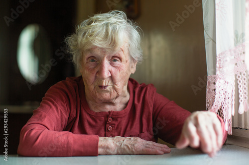 Elderly woman emotionally reacts by telling and gesturing.
