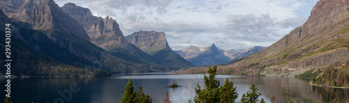 Beautiful Panoramic View of a Glacier Lake with American Rocky Mountain Landscape in the background during a Cloudy Summer Morning. Taken in Glacier National Park, Montana, United States.