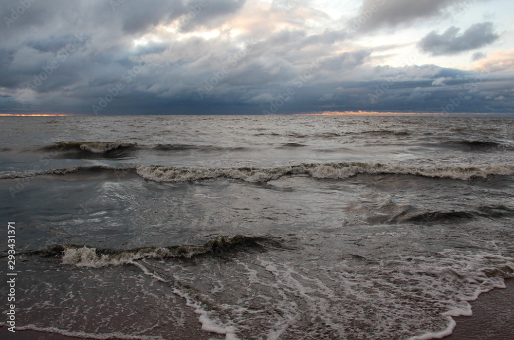 Dramatic sky whit dark clouds and waves on sea