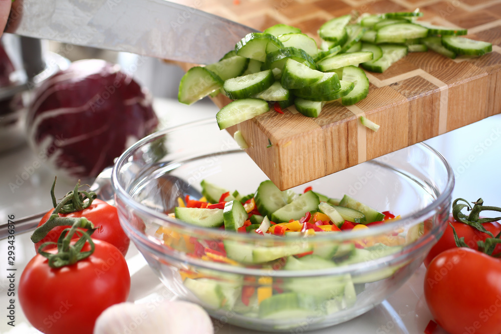Green Chopped Cucumber Slices Pouring Glass Bowl. Healthy Dieting Salad Ingredient. Fresh Organic Vegetable. Hot Chili Pepper and Small Cuke Pieces. Vegetarian Kitchen. Horizontal View Photography Green Chopped Cucumber Slices Pouring Glass Bowl. Healthy Dieting Salad Ingredient. Fresh Organic Vegetable. Hot Chili Pepper and Small Cuke Pieces. Vegetarian Kitchen. Horizontal View Photography