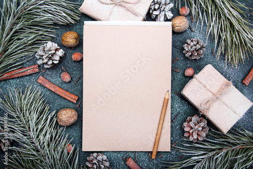 Christmas background with blank notebook surrounded by Christmas decorations. Letter to Santa or Christmas shopping list