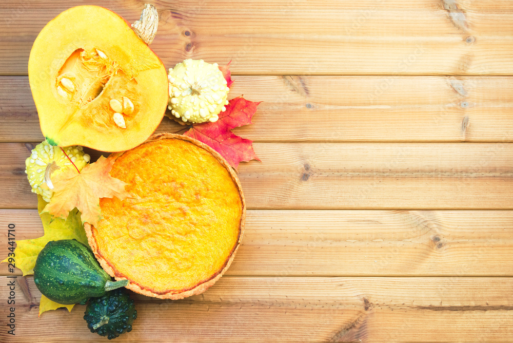 Festive wooden table with pumpkin pie and maple leaves. Happy thanksgiving day Festive wooden table with pumpkin pie and maple leaves. Happy thanksgiving day