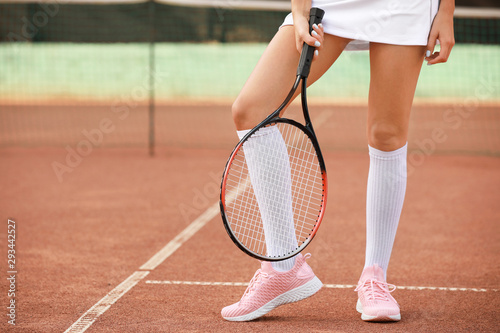 Young woman playing tennis on court © Pixel-Shot
