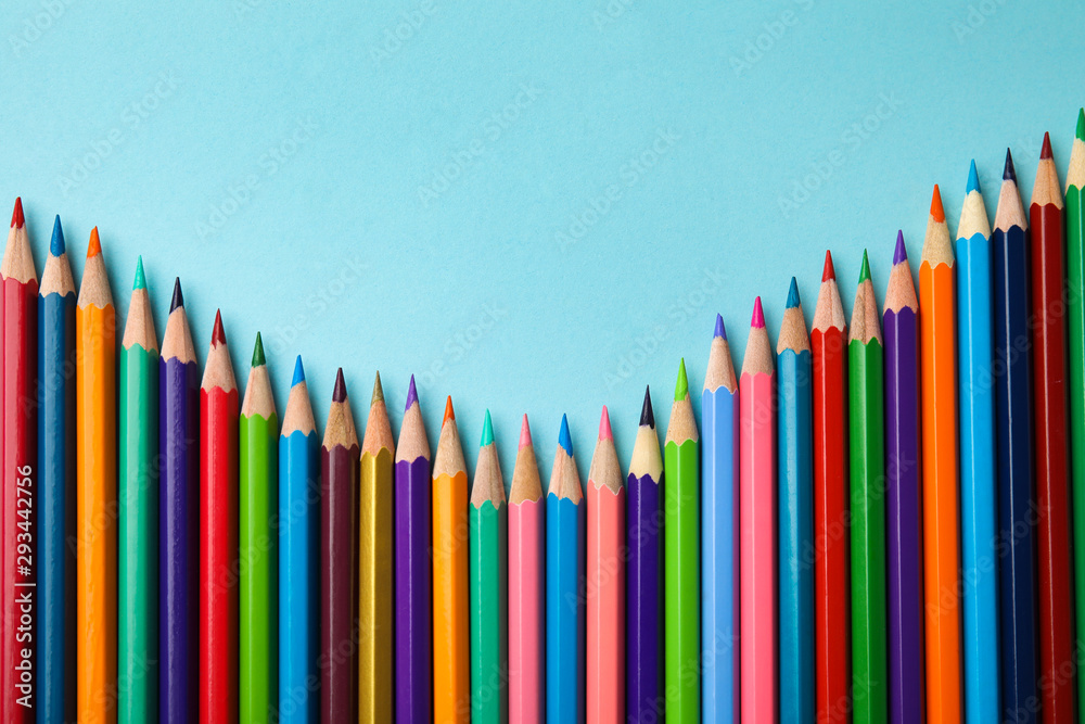 Flat lay composition with color pencils on blue background Flat lay composition with color pencils on blue background