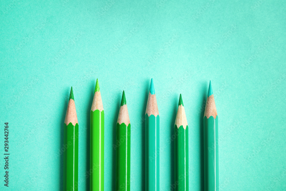 Flat lay composition with color pencils on turquoise background Flat lay composition with color pencils on turquoise background