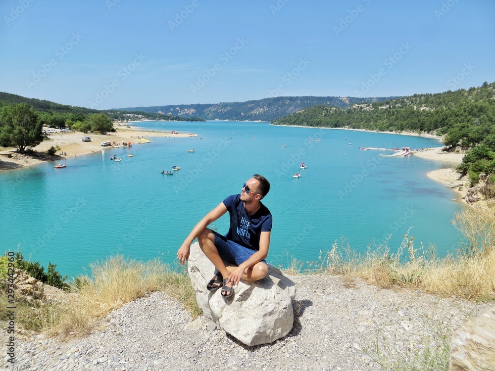 Man sitting on a rock with Saint Croix lake background 