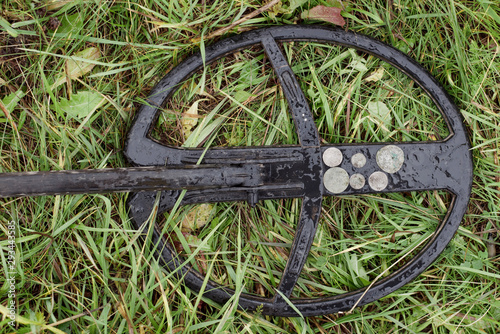 Treasure hunt with a metal detector and a shovel in the field. photo