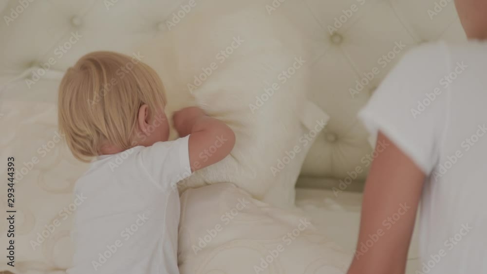 Beautiful happy little boy is playing in the white room. Beautiful happy little boy is playing in the white room.