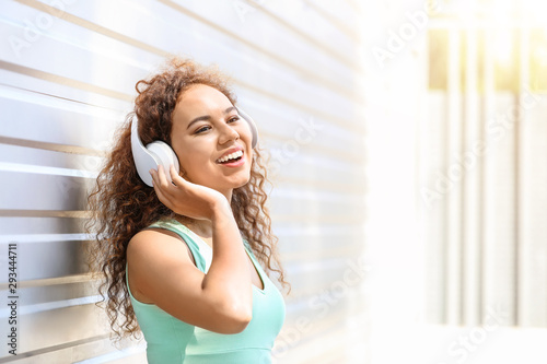 Free Download Beautiful African-American woman listening to music outdoors - GFXLoad