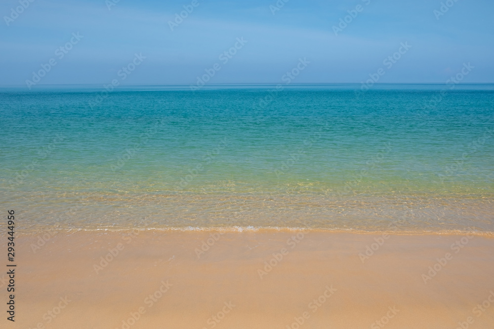 Beautiful empty beach with clear sand and clear blue water.