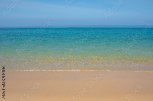 Beautiful empty beach with clear sand and clear blue water.