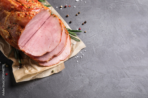 Delicious ham on grey table, top view with space for text. Christmas dinner