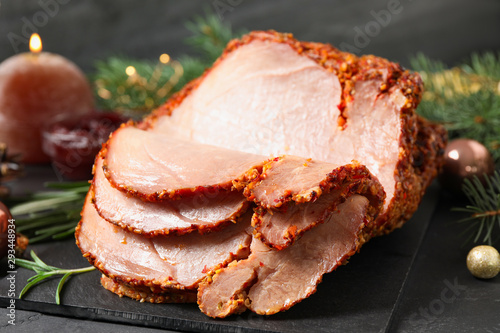 Delicious Christmas ham served on dark table