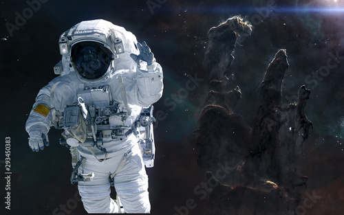 Fototapeta Naklejka Na Ścianę i Meble -  Astronaut on background of the Pillars of Creation. Science fiction. Elements of this image furnished by NASA