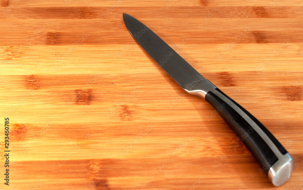 knife on cutting Board on black background
