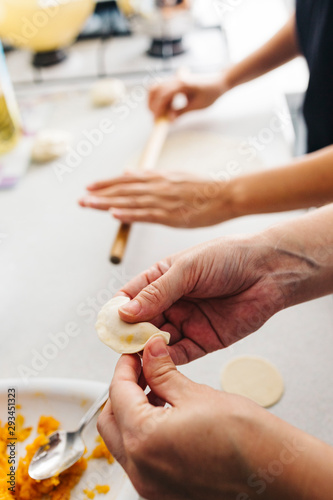 Close up hands while doing roll out doughs for patty,pastry and raviaoli