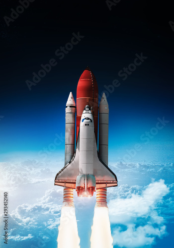 Space shuttle launch in outer space from Earth. Rocket on orbit of the planet. Border of blue sky with clouds and dark deep space. .Elements of this image furnished by NASA 