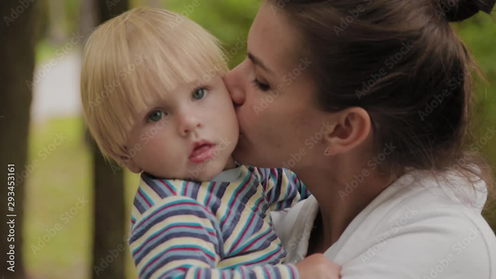 Happy mom walks with her son in the park. Happy mom walks with her son in the park.