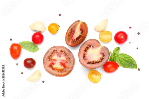 Fresh tomatoes and spices on white background