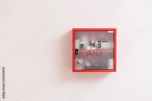 Fotografie Wall mounted first aid kit on light background